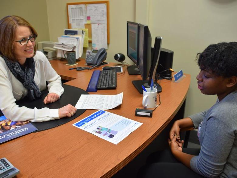 Student speaking with staff member 